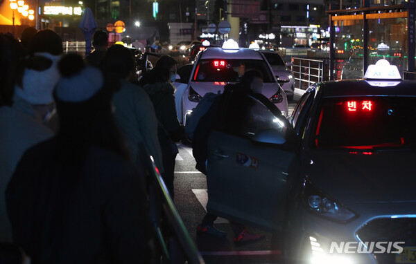 [서울=뉴시스] 고승민 기자 = 서울 택시 심야할증 시간이 오후10시부터 시작되는 지난 1일 서울역 택시승강장에서 시민들이 택시를 타고 있다. 